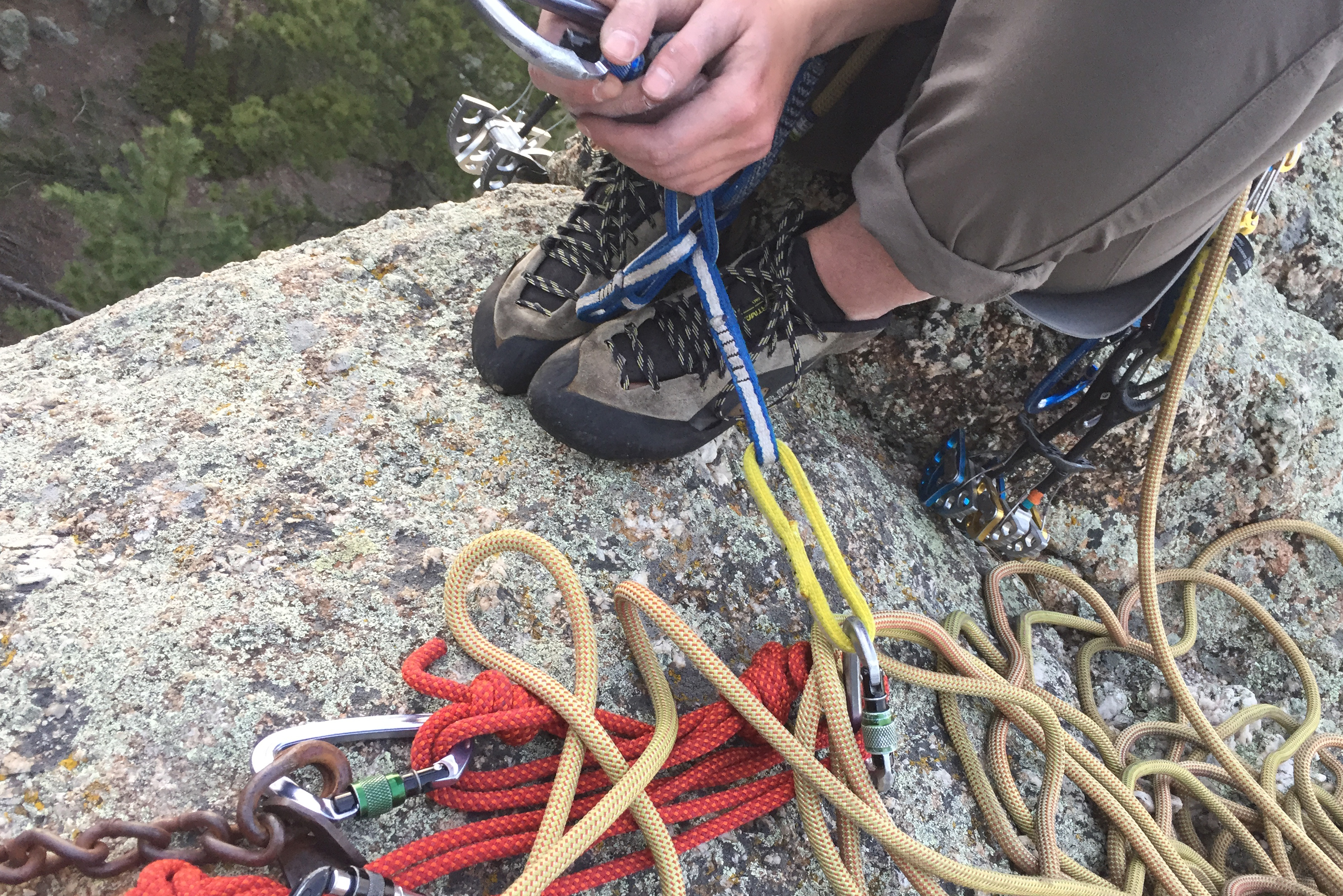 Close up of a rock climber Adjusting ropes by feet