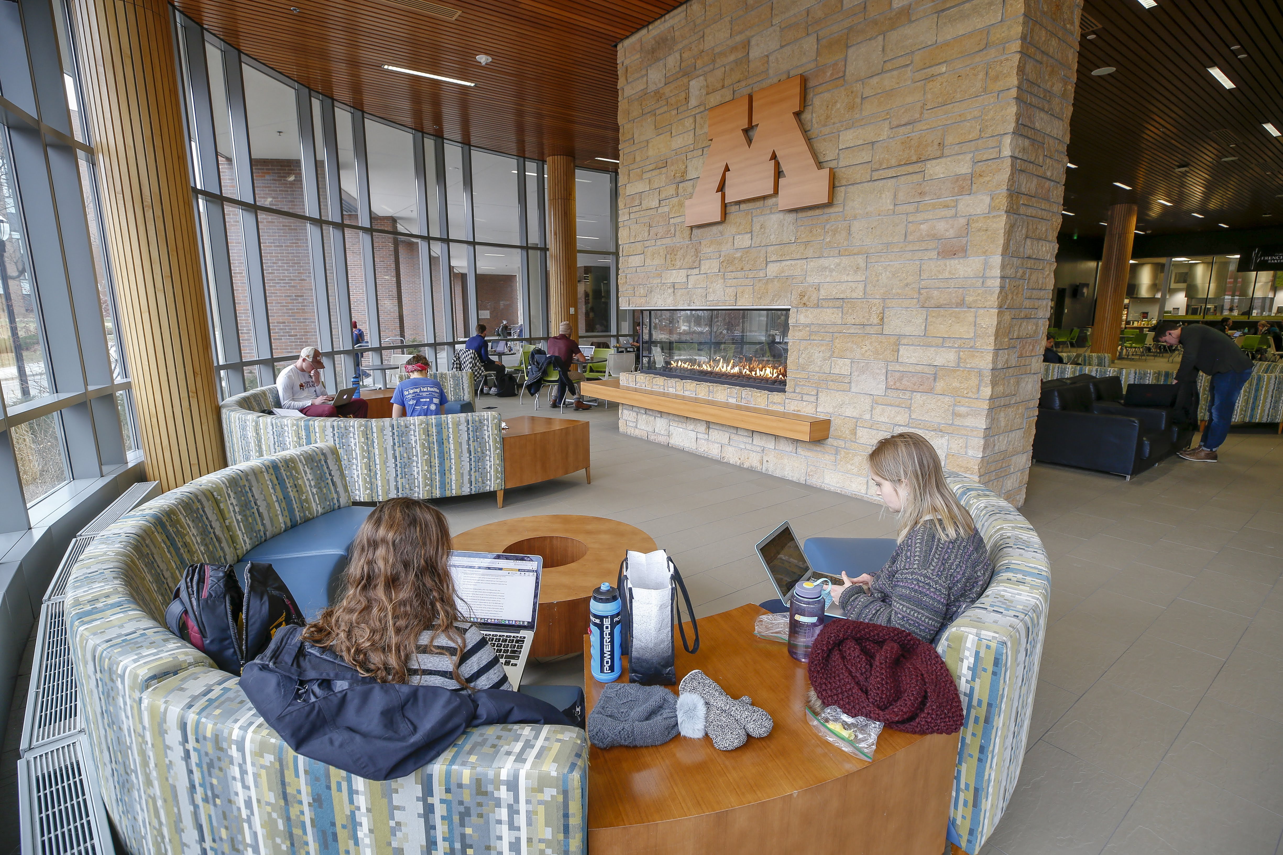 lobby with fireplace and students studying
