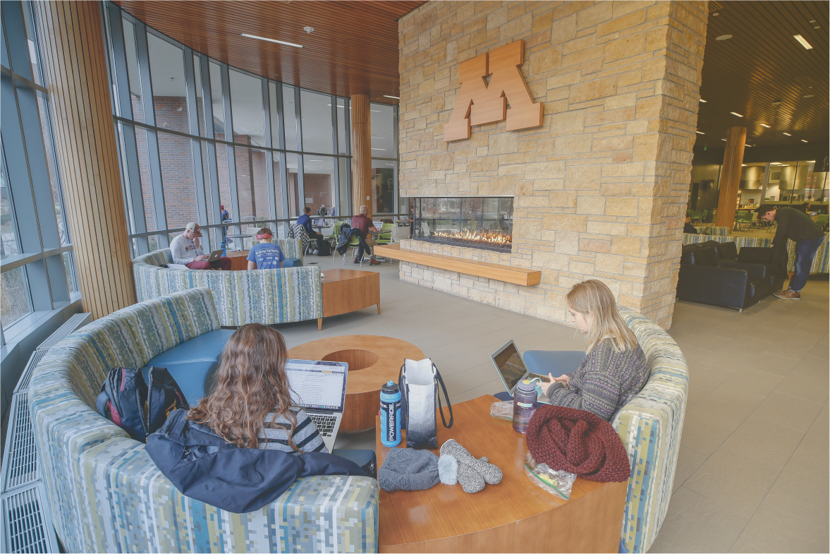 students studying in lobby near fire