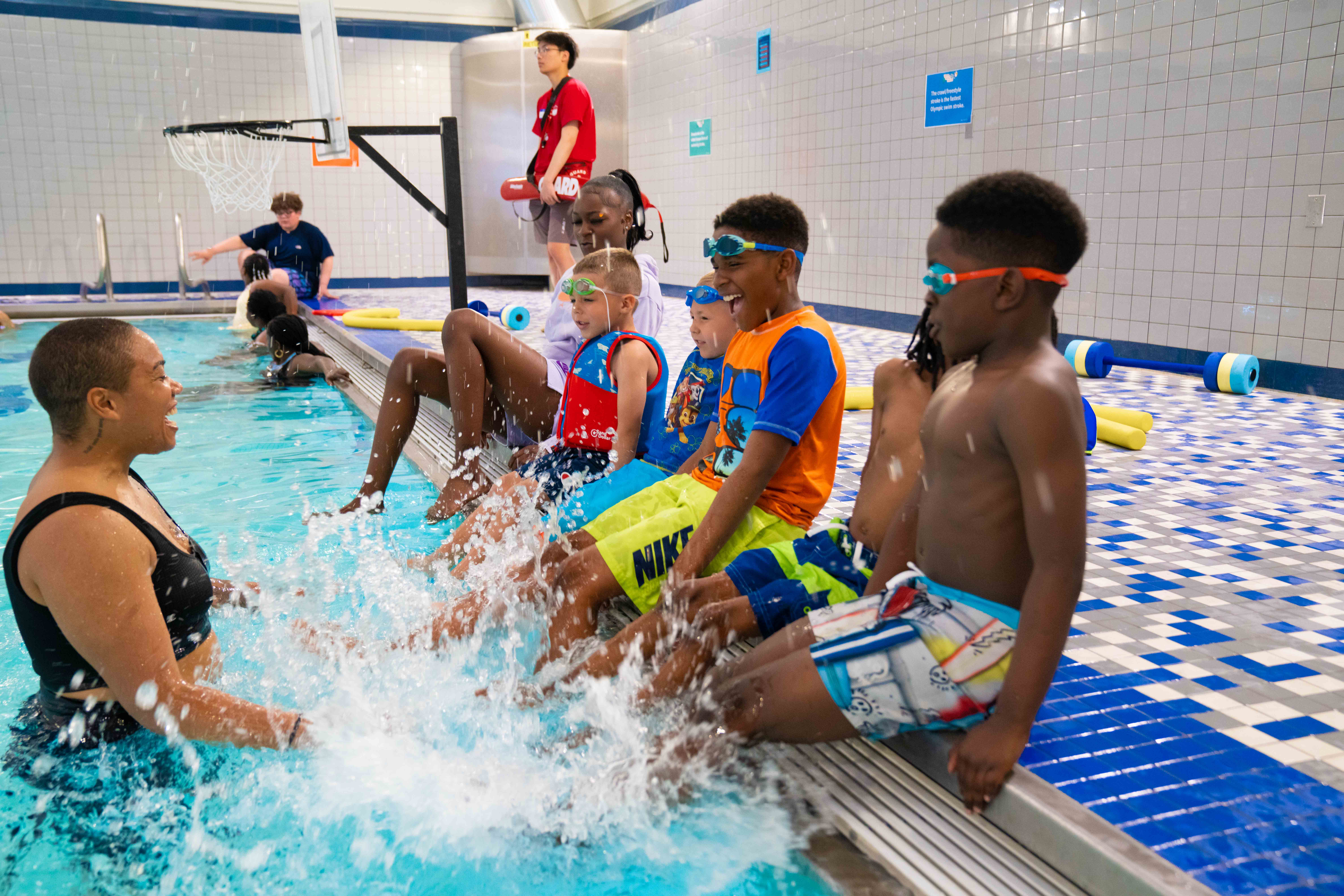 photo of kids splashing their legs in a pool 