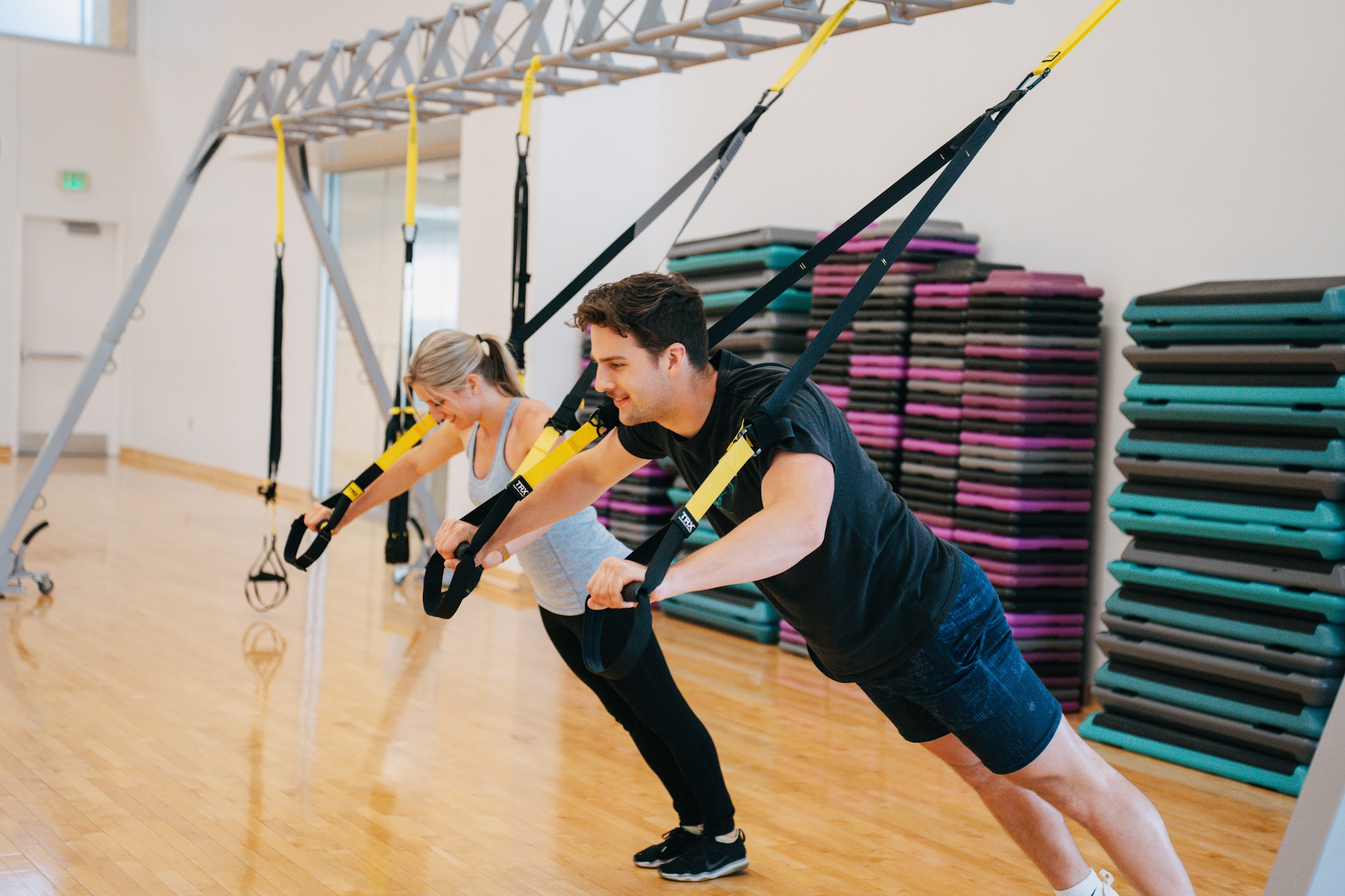 2 people using the TRX bands