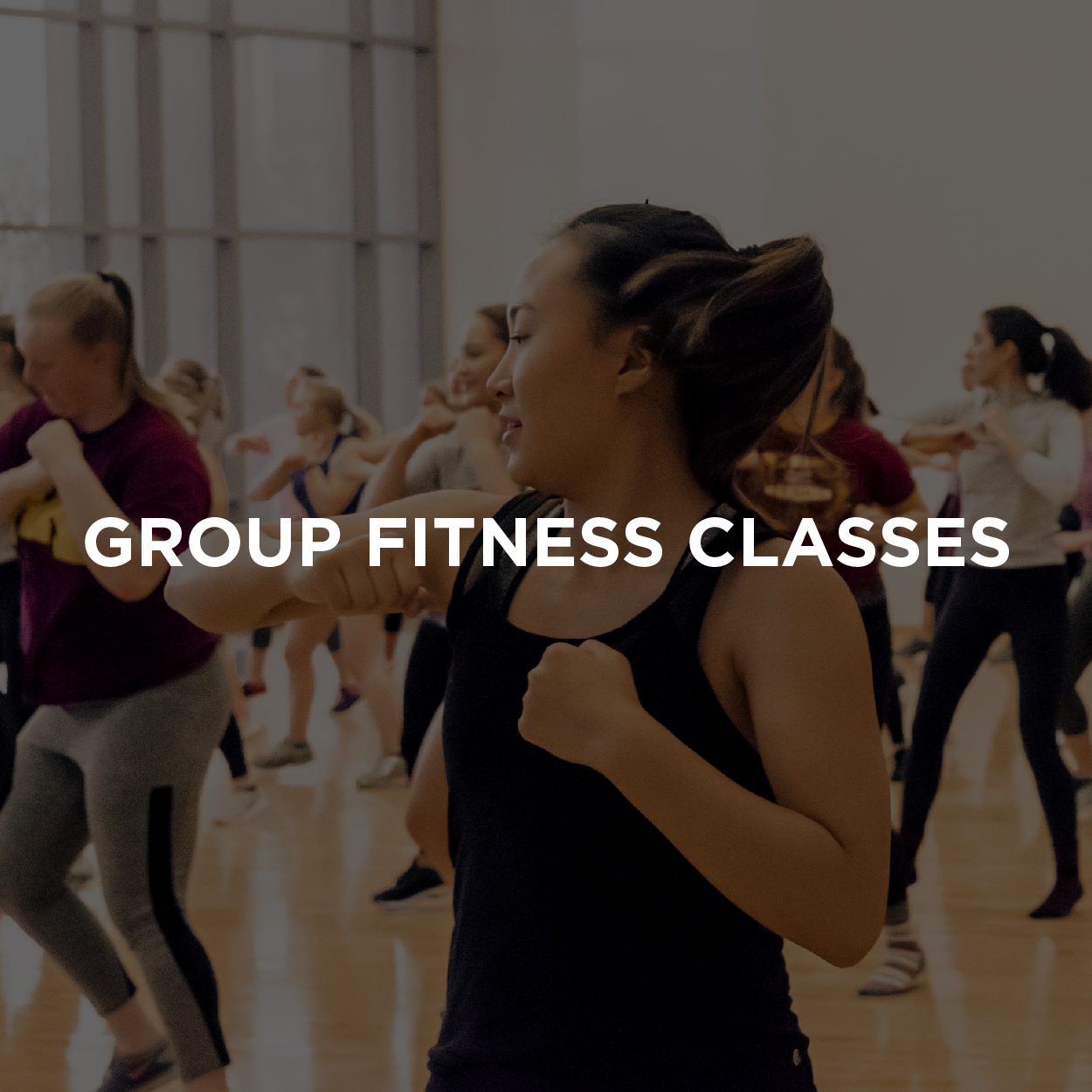 group of students participating in a high energy group fitness class